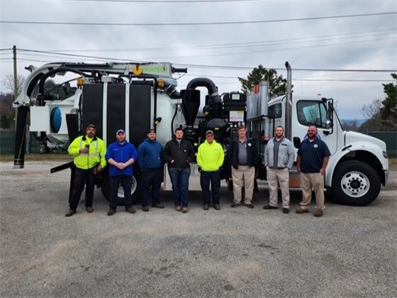 :  L-R  Michael Edwars (Storm Water Division Heavy Equipment Operator), Randy Bell (Fleet Manager and Master Technician), Adam Knudtson (Fleet Services Technician), Logan Ridge (Laborer II and Commercial Driver), Jimmy Ruffner (Laborer II and Commercial Driver), Ricky Reeves (Streets Division and Storm Water Division Supervisor), Justin Headrick (Facilities Manager and key to the procurement process on which type unit to purchase for this endeavor), James Allen (Solid Waste Supervisor and Commercial Driver). 